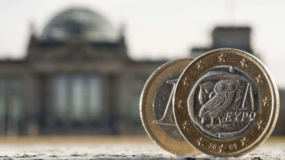 Dos monedas de euro, una de ellas acu&ntilde;ada en Grecia, fotografiadas delante del Bundestag en Berl&iacute;n (Alemania)