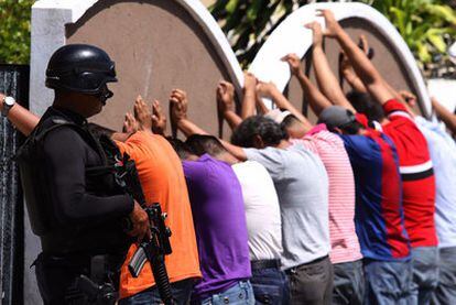 Un policía vigila, en la jornada electoral de ayer, a una decena de detenidos en Veracruz por presunta tenencia de armas cortas.