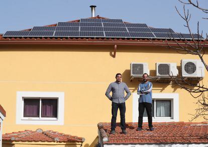 Ángel Abraham (izquierda) y su hermano Abraham, con las placas de energía solar que han instalado en su casa de Pozuelo, en Madrid.