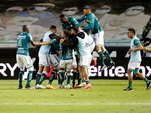 Leon's Yairo Moreno is congratulated by teammates after scoring his side's second goal against Pumas during their Mexican soccer league second-leg final match in Leon, Mexico, Sunday, Dec. 13, 2020. (AP Photo/Eduardo Verdugo)