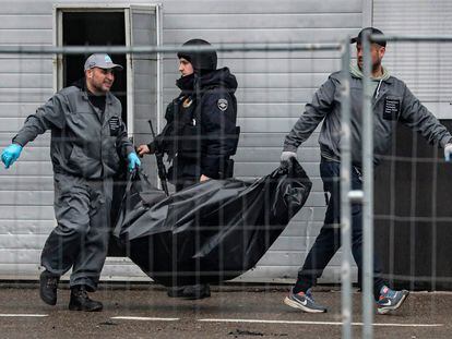 Operarios trasladan el cadáver de una víctima del atentado en la sala Crocus, este sábado en Krasnogorsk.