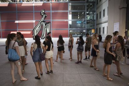 Varias turistas esperan para comprar su entrada del Museo Reina Sofía junto a la escultura 'Brushstroke' ('Pincelada') de Roy Lichtenstein, en el patio del edificio Nouvel.