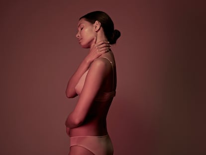 Young woman photographed on studio with coloured lights