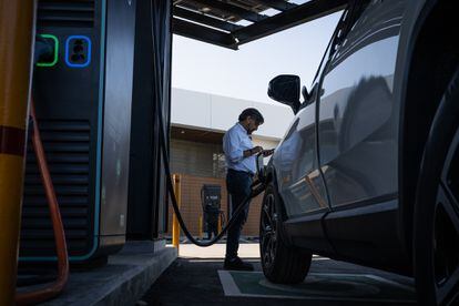 A man charges his car at the Evergo Connect electric station in Punta Cana.