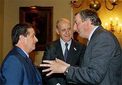 Néstor Kirchner (derecha) conversa con Eduardo Duhalde (izquierda) delante del ministro de Economía, Roberto Lavagna.