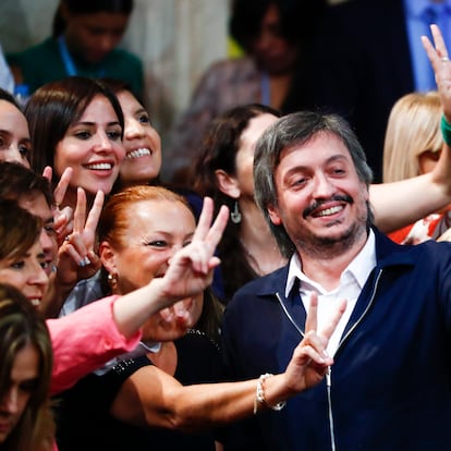 Congressman Maximo Kirchner, center, son of Vice President Cristina Fernandez, flashes a victory sign alongside other lawmakers at Congress as they wait for the arrival of Argentina's President Alberto Fernandez in Buenos Aires, Argentina, Sunday, March 1, 2020. (AP Photo/Marcos Brindicci)