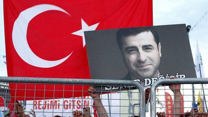 A supporter of Turkey's main pro-Kurdish Peoples' Democratic Party holds a portrait of their jailed former leader and presidential candidate Selahattin Demirtas during a campaign event in Istanbul