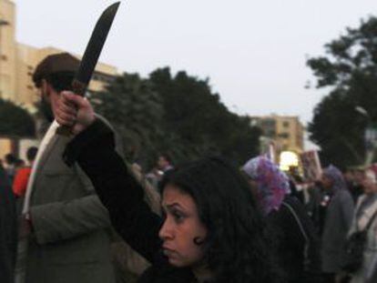 Una mujer levanta un cuchillo en una protesta conta Mohamed Morsi.