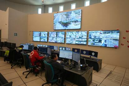 Municipal police observe security camera monitors in Celaya, on February 28.