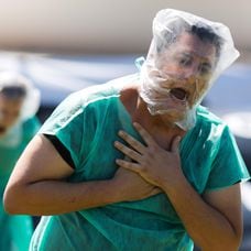 Demonstrators representing patients without oxygen participate in a protest against Brazilian president Jair Bolsonaro and his management of the coronavirus disease crisis, COVID-19, in Brasilia, on January 31, 2021. - The novel coronavirus has killed at least 2,219,793 people worldwide, including 223,945 in Brazil, since the outbreak emerged in China in December 2019, according to a tally from official sources compiled by AFP at 1100 GMT on Sunday. (Photo by Sergio LIMA / AFP)