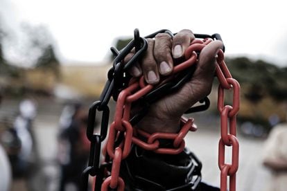 A person holds chains during the demonstrations against the Government of the President of Nicaragua, Daniel Ortega, in San José, Costa Rica on October 12, 2021.  