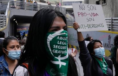 A woman wears a protective face mask with a message that reads in Spanish; "Legal abortion safe and free" during an abortion rights demonstration, outside the offices of the Bolivian Episcopal Conference, in La Paz, Bolivia, Friday, Oct. 29, 2021. The case of an 11-year-old girl raped and five months pregnant, who is in a reception center of the Catholic Church, has rekindled the debate on abortion in Bolivia. (AP Photo/Juan Karita)