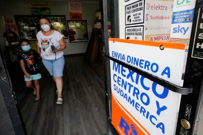 Una mujer sale de una tienda que ofrece servicios para enviar remesas a México y Centroamérica