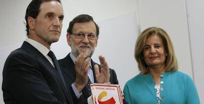 En el centro, el presidente del Gobierno, Mariano Rajoy, acompañado por la ministra de Empleo, Fátima Báñez