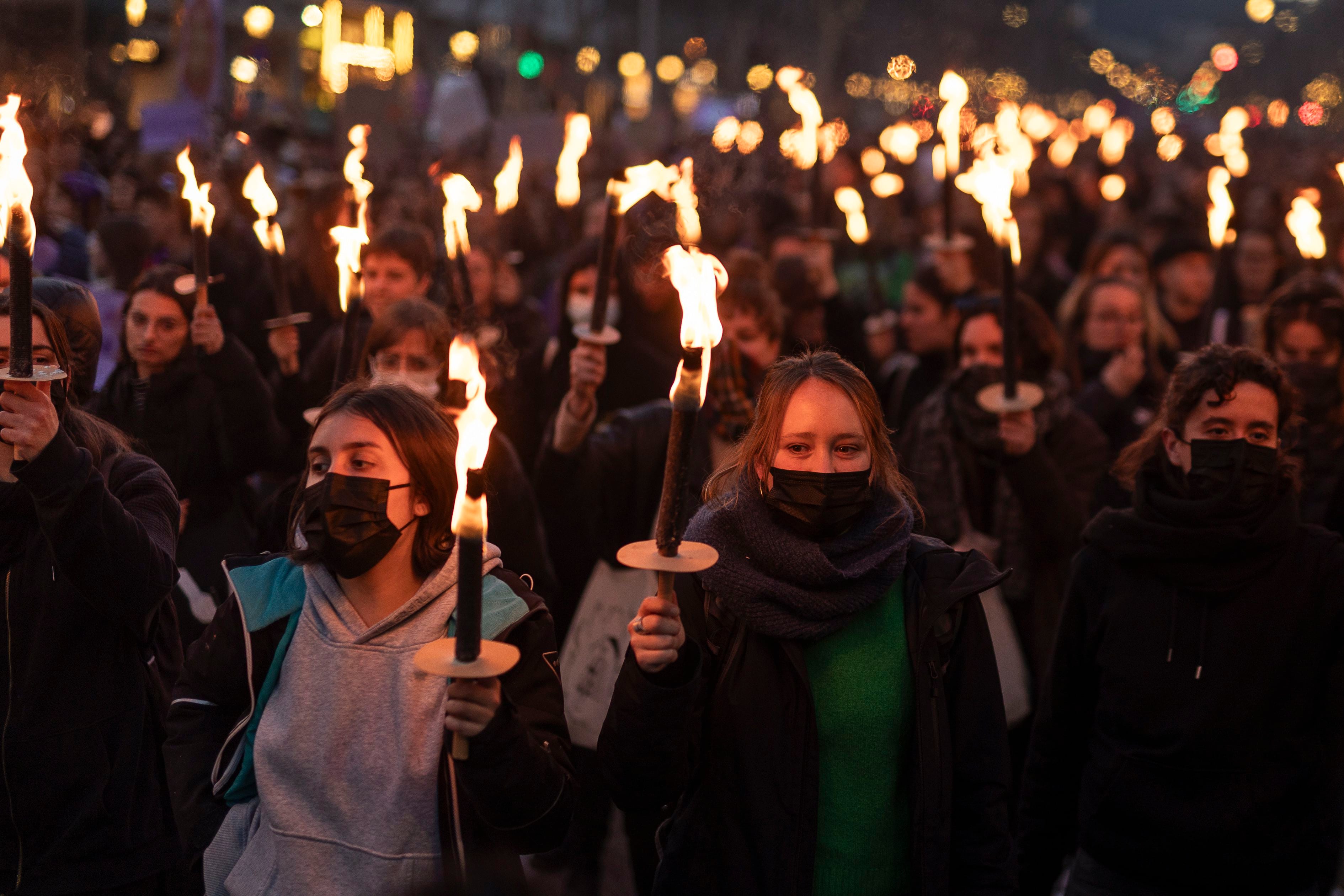 Manifestantes portaban antorchas durante la marcha en Barcelona por el 8M, este viernes.