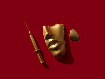 Gold colored syringe and face/ mask on the red background.