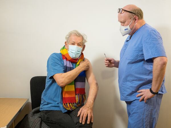 Actor Ian McKellen looks on as he receives the Pfizer-BioNTech COVID-19 vaccine from GP Dr Phil Bennett-Richards at the Arts Research Centre, Queen Mary University Hospital, in London, Britain December 16, 2020. Jeff Moore/Handout via REUTERS ATTENTION EDITORS - THIS IMAGE WAS PROVIDED BY A THIRD PARTY. NO RESALES. NO ARCHIVES. MANDATORY CREDIT.