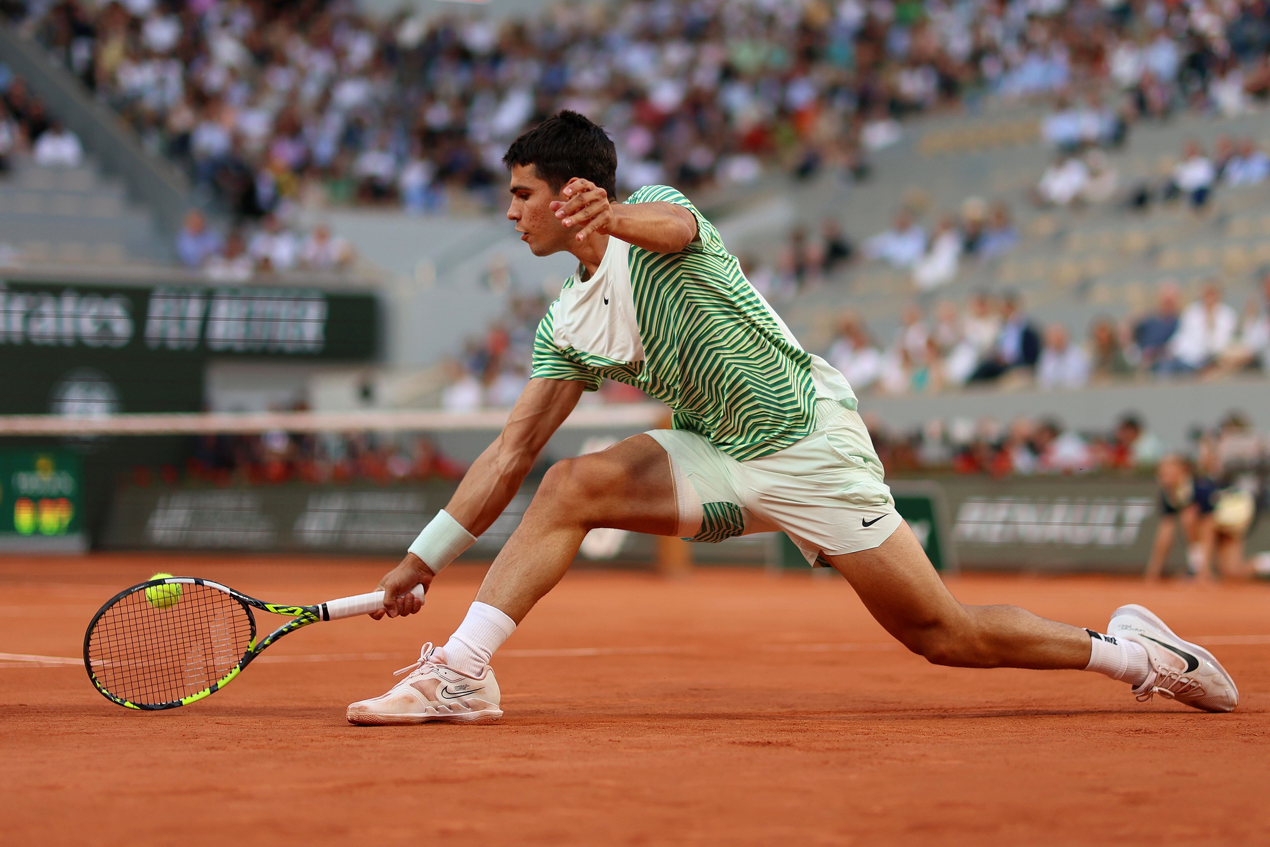 PARIS, FRANCE - JUNE 06: Carlos Alcaraz of Spain plays a backhand against Stefanos Tsitsipas of Greece during the Men's Singles Quarter Final match on Day Ten of the 2023 French Open at Roland Garros on June 06, 2023 in Paris, France. (Photo by Clive Brunskill/Getty Images)