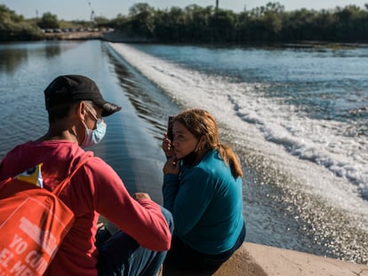 Una pareja inmigrante de Cuba espera intentar cruzar el Río Grande desde Ciudad Acuña, México, hacia Del Río, Texas, el domingo 19 de septiembre de 2021.