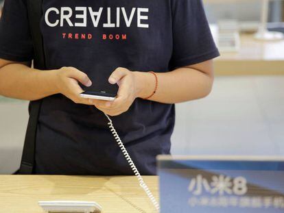 Un cliente prueba un tel&eacute;fono de Xiaomi en una tienda. 