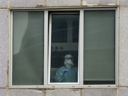 Un sanitario, en una de las ventanas del Hospital Universitario La Paz de Madrid