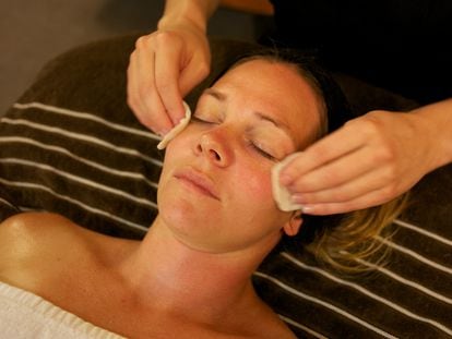 Una mujer recibe un tratamiento de belleza facial en un spa de belleza.