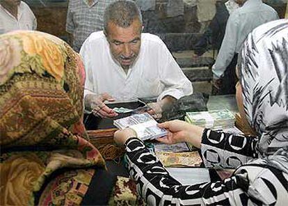 Los iraquíes han acudido a los bancos a cambiar sus viejos billetes con el rostro de Sadam por los nuevos dinares.