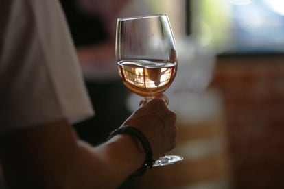 A person holds a glass of wine in Aguascalientes, Mexico.