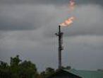 (FILES) In this file photo taken on March 26, 2018 A gas flare burns at the Batan flow station operated by Chevron under a joint-venture arrangement with the Nigerian National Petroleum Corporation (NNPC) for the onshore and offshore assets in the Niger Delta region. - The collapse in oil prices linked to the COVID-19 coronavirus crisis has seen Nigeria's revenues from crude dry up and left Africa's largest economy more threatened than ever by its dependence on black gold. 
 The price of oil may have rebounded in recent days to over $30 a barrel, but the future remains bleak for the continent's largest producer, which relies on crude for some 90 percent of its foreign exchange earnings. (Photo by PIUS UTOMI EKPEI / AFP)