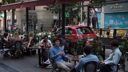 Operarios instalan un toldo en una terraza puesta en plazas de aparcamiento en la calle de Ponzano el pasado junio.
