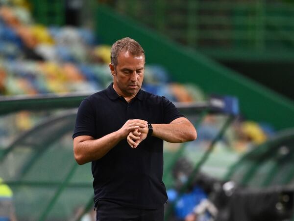 Bayern's interim head coach Hans-Dieter Flick looks at the clock during the Champions League semifinal soccer match between Lyon and Bayern at the Jose Alvalade stadium in Lisbon, Portugal, Wednesday, Aug. 19, 2020. (Franck Fife/Pool via AP)