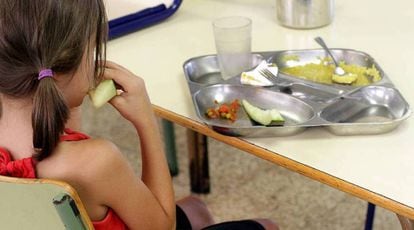Una niña almuerza en un comedor escolar. 