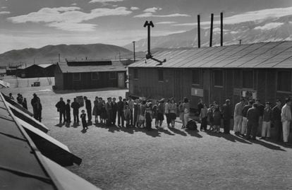 En los campos, a cada familia se le entregaron placas con un número grabado para cada miembro, que fueron utilizadas para identificarse. En la imagen, una larga cola de gente espera frente a un edificio del Centro de Reubicación de la Guerra 'Manzanar' en California, en 1943.