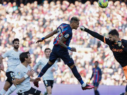 Barcelona's Raphinha scores his side's opening goal during Spanish La Liga soccer match between Barcelona and Valencia at the Camp Nou stadium in Barcelona, Spain, Sunday, March 5, 2023. (AP Photo/Joan Monfort)