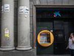BARCELONA, SPAIN - OCTOBER 06: Posters supporting the referendum vote are seen on a wall next to an ATM machine at a branch of Spain's CaixaBank on October 6, 2017 in Barcelona, Spain. Tension between the central government and the Catalan region have increased after last weekend's independence referendum. Spanish shares and bonds have been hit hard since the political turmoil with fears Spain could be on the brink of a financial crisis should the civil unrest continue. Two of Spain's largest banks, Banco de Sabadell and CaixaBank have both held meetings discussing steps to transfer their registered headquarters to other cities in Spain. The Spanish government suspended the Catalan parliamentary session planned for Monday in which a declaration of independence was expected to be made. (Photo by Chris McGrath/Getty Images)