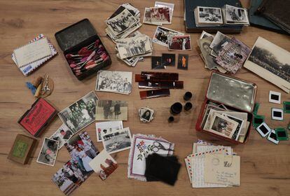 Garbi Galatea's work table: needles, scissors, colored threads and old photographs.
