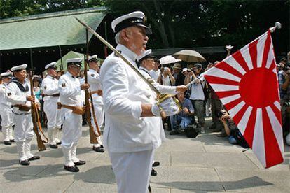 Veteranos de la marina japonesa sujetan la bandera imperialista del Sol Naciente en el santuario de Yasukuni.