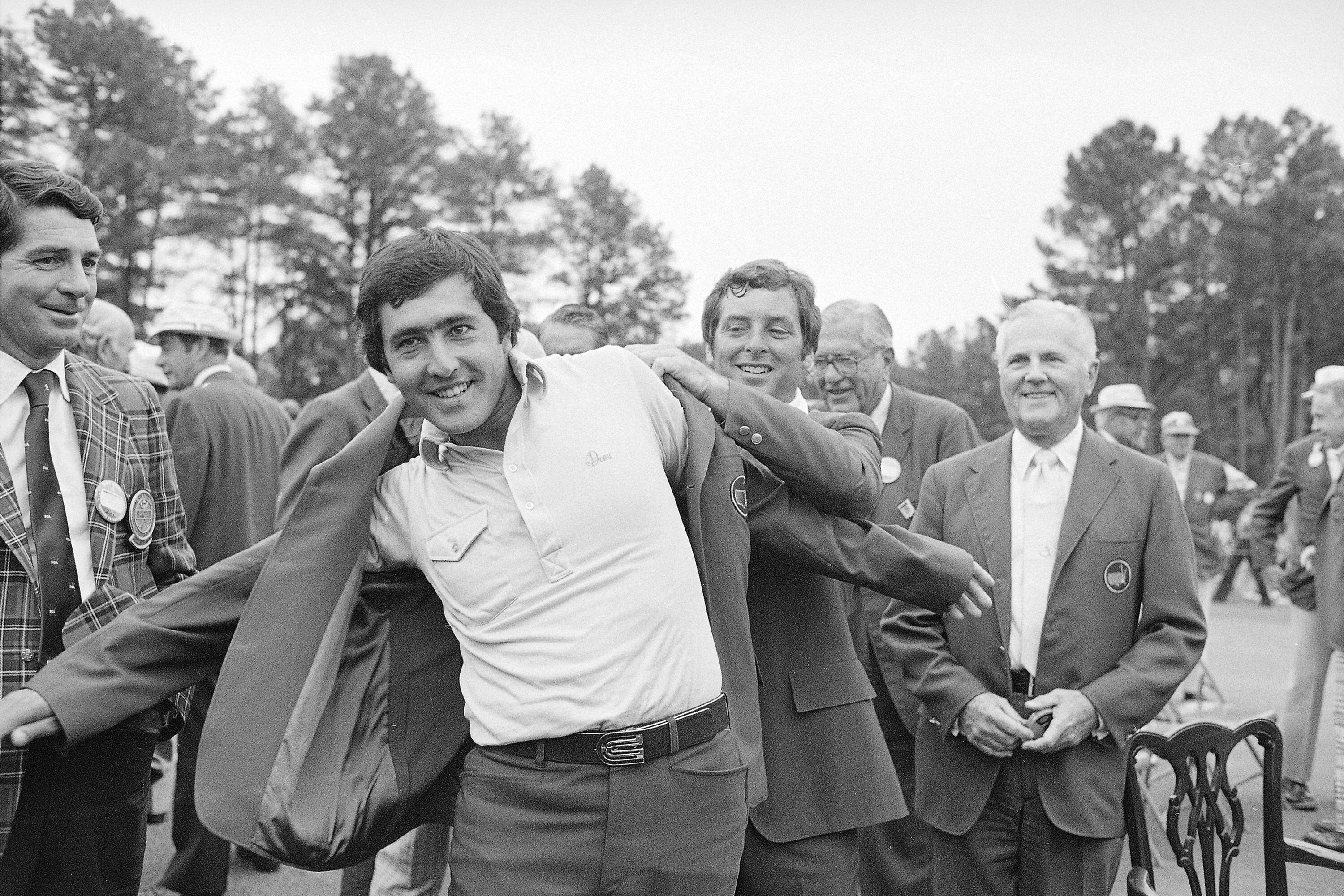 Severiano Ballesteros, winner of the 1980 Masters title at the Augusta National Golf Club, receives the Green Coat from last year's winner, Fuzzy Zoeller, April 14, 1980