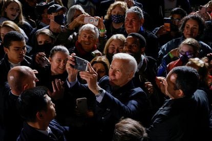 U.S. President Joe Biden takes a picture in the crowd while campaigning for Democratic candidate for governor of Virginia Terry McAuliffe at a rally in Arlington, Virginia, U.S. October 26, 2021. REUTERS/Jonathan Ernst
