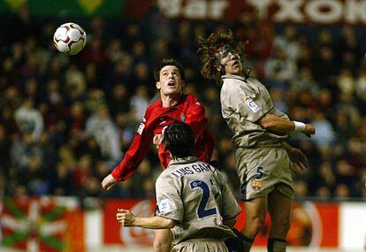 Puyol disputa un balón aéreo con Milosevic durante un duelo contra Osasuna en El Sadar.