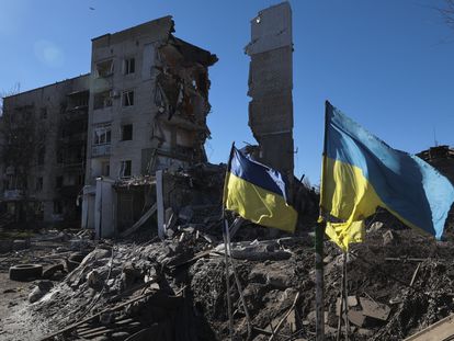 Banderas ucranias ondean frente a un edificio residencial destrozado en Órijiv, cerca de Robotine, en el sur de Ucrania el 28 de febrero.
