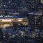 This picture shows the National Stadium, the main venue for the Tokyo 2020 Olympic and Paralympic Games, lit up at dusk in Tokyo on July 16, 2021. (Photo by Charly TRIBALLEAU / AFP)