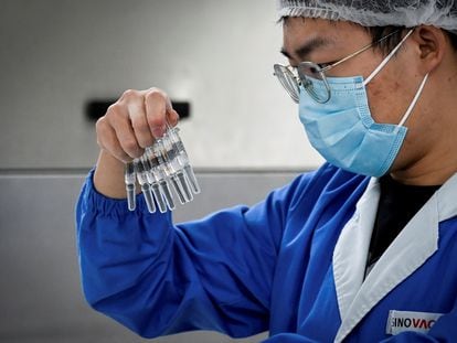 Un trabajador examina un lote de vacunas en la fábrica de Sinovac en Pekín.