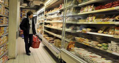 Una clienta frente a las estanter&iacute;as de un supermercado