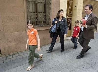 Jordi Hereu camina por Les Corts junto a su mujer y sus dos hijos.