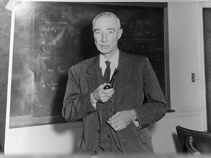 (Original Caption) Robert Oppenheimer (1904-1967), American physicist, Director of the Manhattan project. Undated photograph, standing before blackboard, holding pipe.