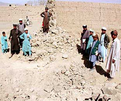 Habitantes de Kabul contemplan el cráter provocado por una bomba.