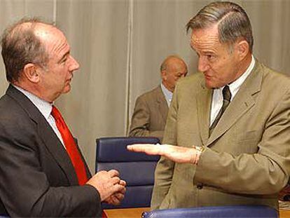 Rodrigo Rato conversa con su colega francés, Francis Mer, durante el Ecofin de ayer.