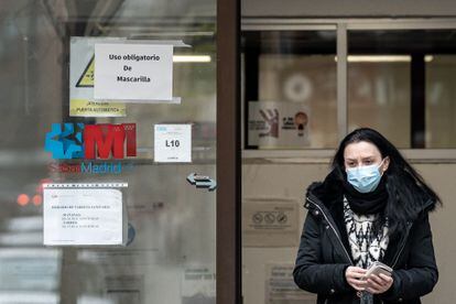 Una mujer sale con mascarilla del centro de salud de Guzmán El Bueno, a 10 de enero de 2024, en Madrid (España).