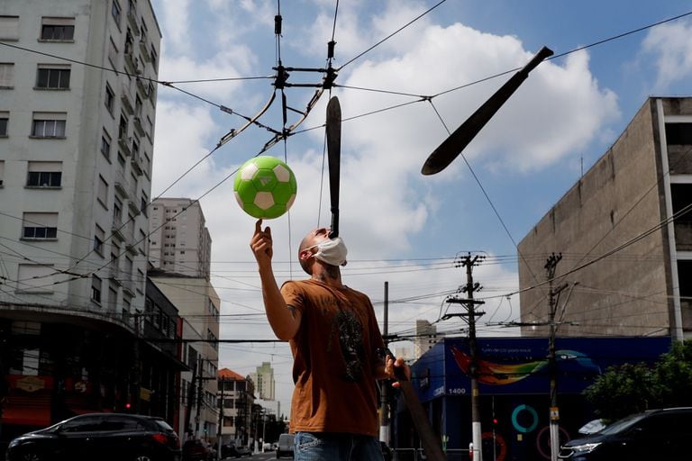 A man juggles on a street in São Paulo (Brazil).